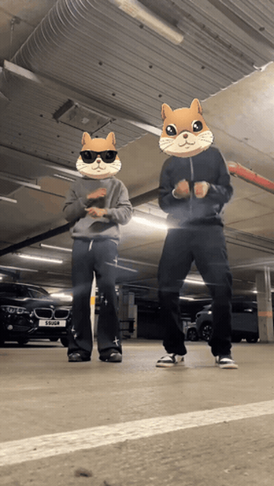 Two People Wearing Hamster Masks Are Dancing In A Garage GIF