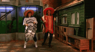 Two People Wearing Sombrero 'S Are Dancing In A Room GIF