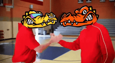 Two People With Cartoon Faces On Their Heads Shake Hands On A Basketball Court GIF