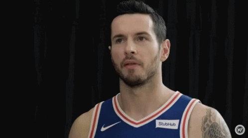 Two Philadelphia 76Ers Players Are Standing Next To Each Other And Smiling . GIF