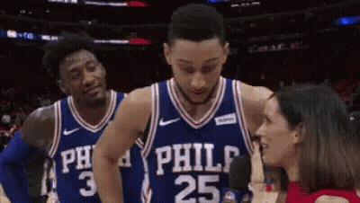 Two Philadelphia 76Ers Players Are Talking To A Reporter On The Court GIF
