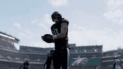 Two Philadelphia Eagles Players Are Standing On A Field GIF