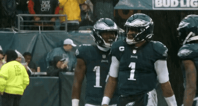 Two Philadelphia Eagles Players Number 11 And C Stand Next To Each Other On The Field GIF
