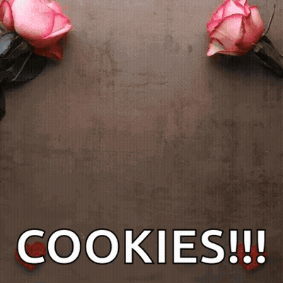 Two Pink Roses Are Sitting On A Table Next To The Words Cookies GIF