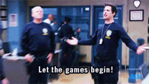 Two Police Officers Are Standing In A Room And One Of Them Is Saying Let The Games Begin . GIF