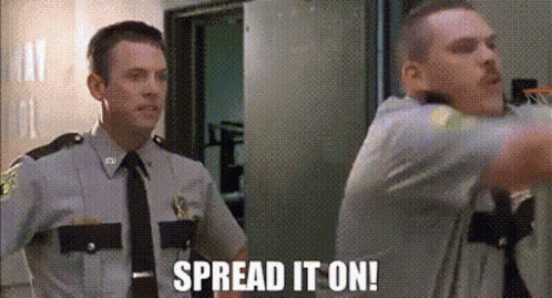 Two Police Officers Are Standing Next To Each Other In A Room And One Of Them Is Saying `` Spread It On '' . GIF