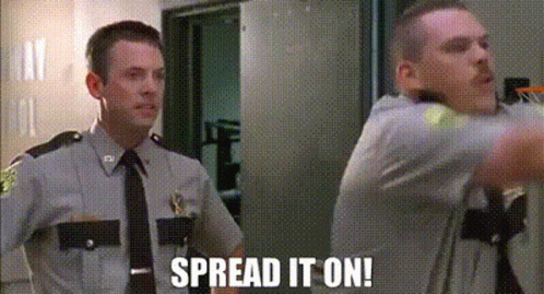 Two Police Officers Are Standing Next To Each Other In A Room And One Of Them Is Saying `` Spread It On '' . GIF