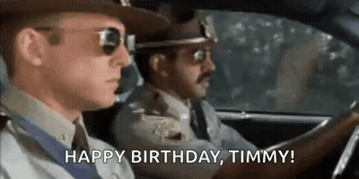 Two Police Officers Driving Car Saying Happy Birthday Timmy GIF