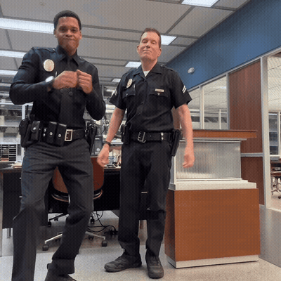 Two Police Officers One With L.A. Badge GIF