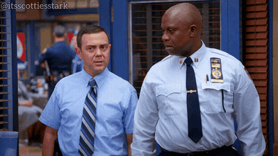Two Police Officers One With NYPD Badge GIF
