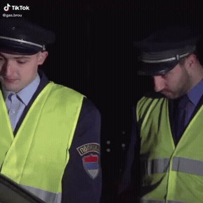 Two Police Officers One With Policija Patch GIF