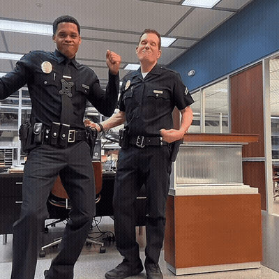 Two Police Officers Posing With Number 1 GIF