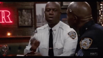 Two Police Officers Standing In Bar Talking GIF