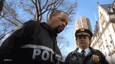 Two Police Officers Standing With Police Uniforms GIF