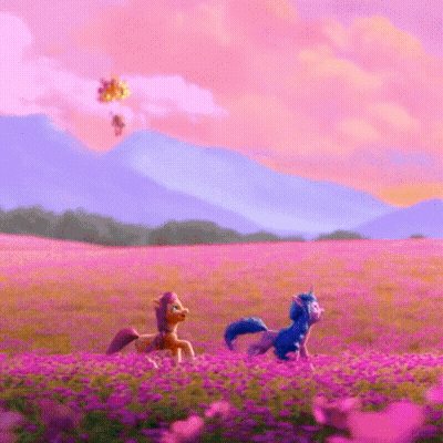 Two Ponies Are Walking Through A Field Of Purple Flowers . GIF