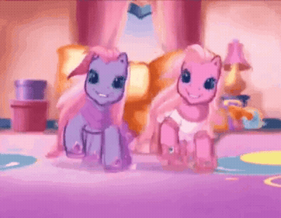 Two Ponies Standing Next To Each Other In Living Room GIF