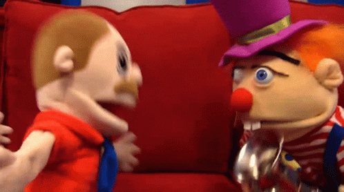Two Puppets Are Sitting On A Red Couch And One Has A Top Hat On GIF