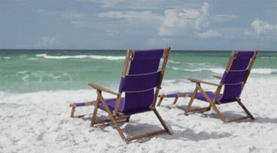 Two Purple Beach Chairs Sit On A Sandy Beach GIF