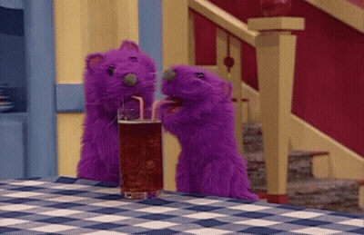 Two Purple Stuffed Animals Drinking Soda Through Straw