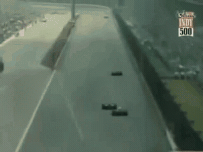 Two Race Cars Racing On Track GIF