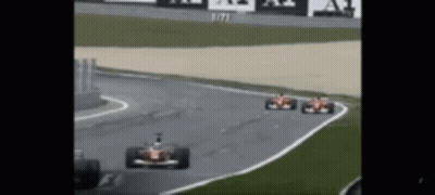 Two Race Cars Racing On Track GIF