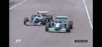 Two Racing Cars On A Race Track With The Year 1994 On The Bottom GIF