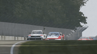 Two Racing Cars On Track With Goodyear GIF