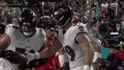 Two Ravens Football Players Holding Ball GIF