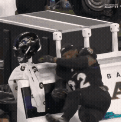 Two Ravens Players Hugging In Front Of ESPN Box GIF