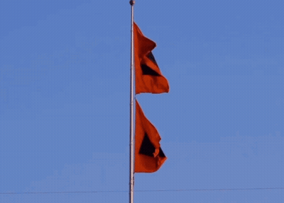 Two Red Flags With Black Squares Flying GIF