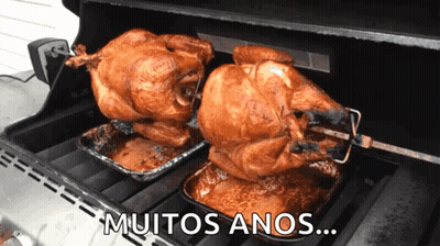 Two Roasted Turkeys On A Grill With The Words " Muitos Anos " Written Below Them GIF