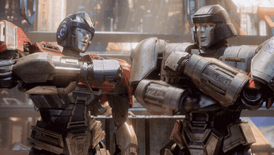 Two Robots Standing Together With Letter O GIF