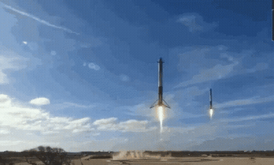 Two Rockets Are Being Launched Into The Sky With A Blue Sky In The Background GIF