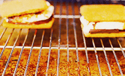 Two S'mores Are Being Cooked On A Grill .. GIF