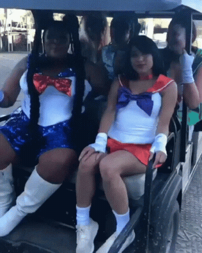 Two Sailor Moon Costumed Women In Golf Cart GIF
