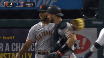Two San Francisco Giants Players Are Hugging Each Other GIF