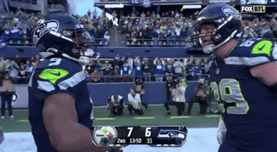 Two Seahawks Players Celebrate A Touchdown During A Game GIF