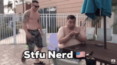 Two Shirtless Men Are Sitting At A Table With The Words Stfu Nerd Written On The Bottom GIF