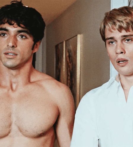 Two Shirtless Men Are Standing Next To Each Other GIF
