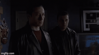 Two Shirtless Men In Dark Room With JVC Box GIF