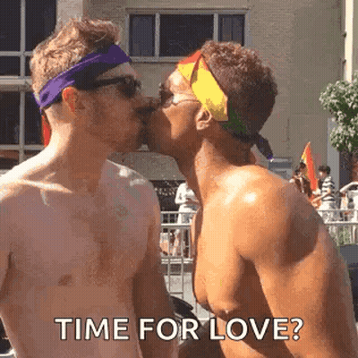 Two Shirtless Men Kissing At Pride Parade Saying Time For Love GIF