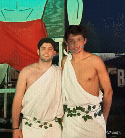Two Shirtless Men Posing In Front Of FB Sign GIF