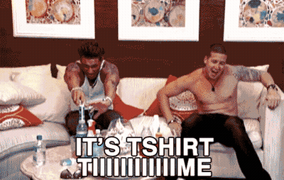 Two Shirtless Men Sit On A Couch With The Words It 'S Tshirt Time Written On The Bottom GIF