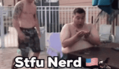 Two Shirtless Men Sitting At A Table With The Words Stfu Nerd Written On The Bottom GIF