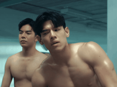 Two Shirtless Men Standing In Dark Room GIF