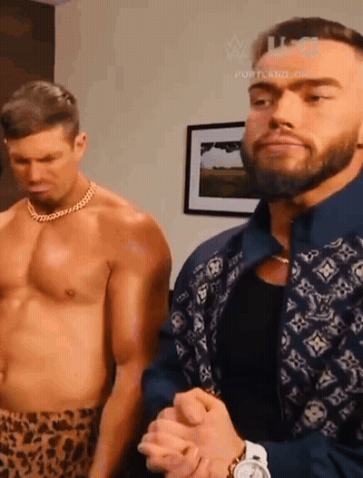 Two Shirtless Men Standing Next To Each Other In A Room . GIF