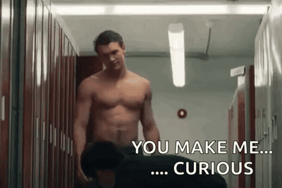 Two Shirtless Men Talking In Locker Room GIF