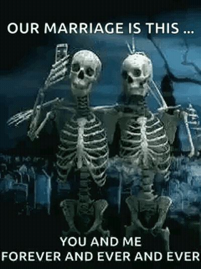 Two Skeletons Are Standing Next To Each Other In A Cemetery Taking A Selfie . GIF