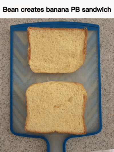 Two Slices Of Bread On A Cutting Board With The Words Bean Creates Banana Pb Sandwich Below Them GIF