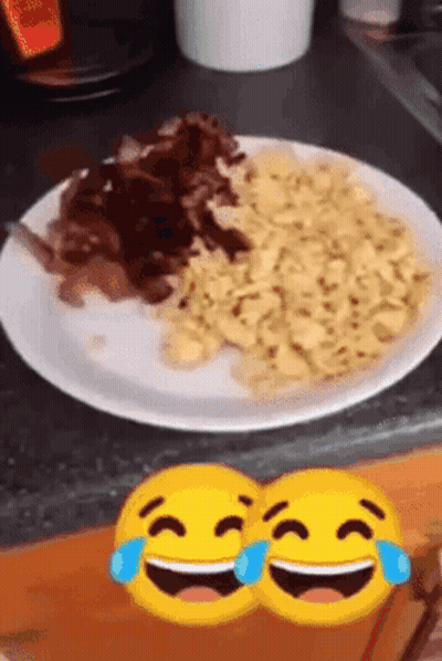 Two Smiley Faces Laughing Next To Plate Of Food GIF